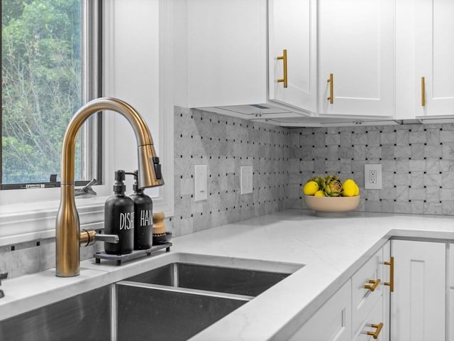 168 Maple St, Boston, MA 02132 - kitchen featuring tasteful backsplash, white cabinetry, light stone counters, and plenty of natural light