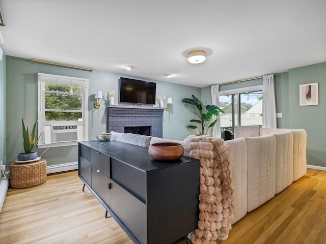 168 Maple St, Boston, MA 02132 - living room featuring cooling unit, light wood finished floors, a baseboard radiator, and plenty of natural light