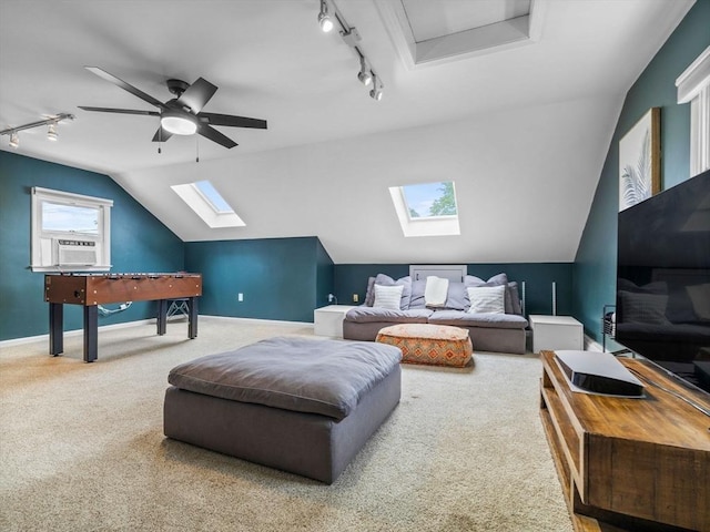 168 Maple St, Boston, MA 02132 - carpeted living room featuring track lighting, a skylight, vaulted ceiling, and ceiling fan