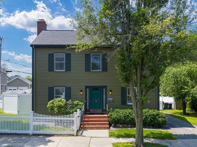 168 Maple St, Boston, MA 02132 - view of front of property with a chimney, a shingled roof, and a fenced front yard