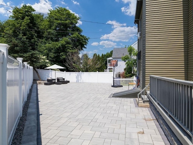 168 Maple St, Boston, MA 02132 - fenced backyard with a patio area and an outdoor hangout area