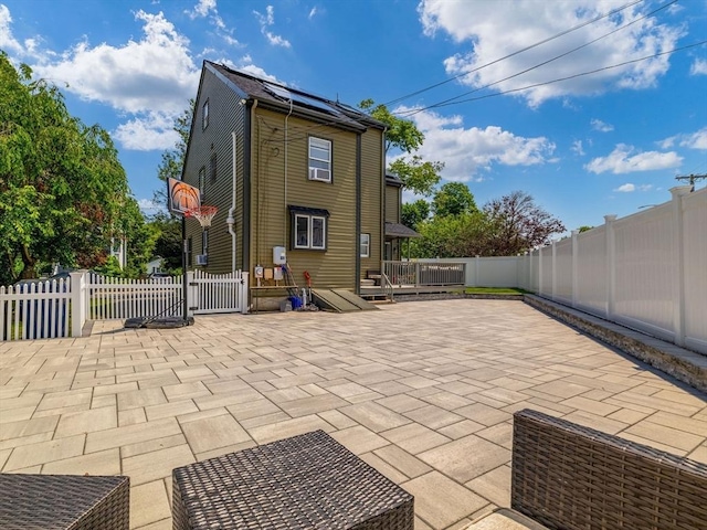 168 Maple St, Boston, MA 02132 - back of house featuring a fenced backyard, a wooden deck, and a patio