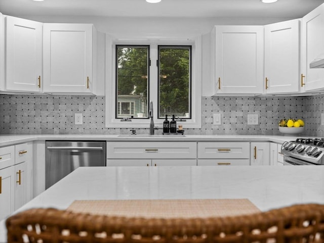 168 Maple St, Boston, MA 02132 - kitchen featuring stainless steel appliances, white cabinets, backsplash, and light stone counters