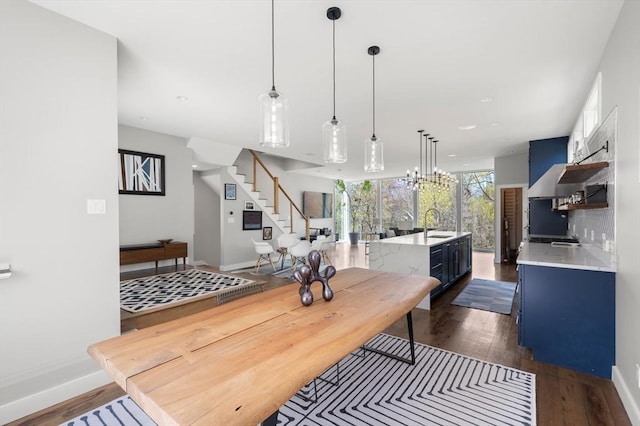 dining space with dark wood-style flooring, baseboards, recessed lighting, and stairway