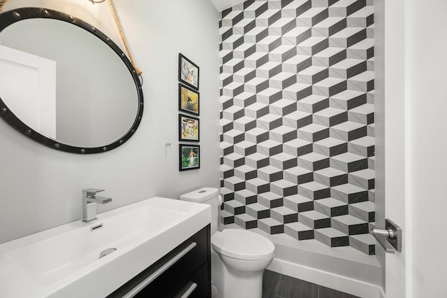 bathroom featuring toilet and vanity