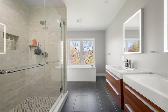 bathroom featuring visible vents, tile patterned flooring, a stall shower, vanity, and baseboards