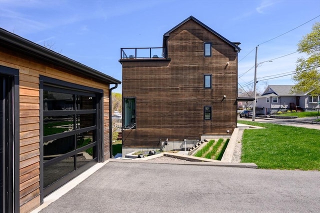 view of side of property with a lawn