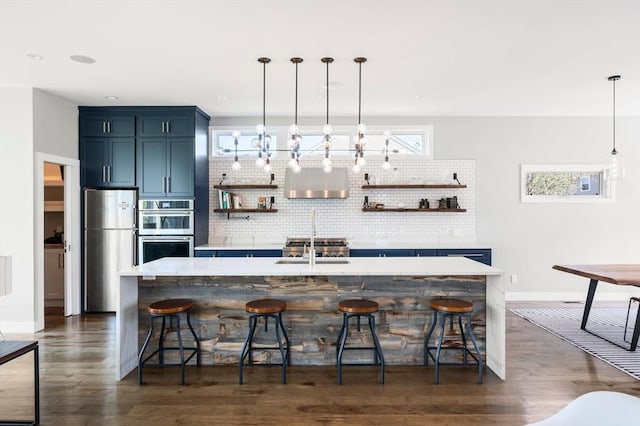 kitchen featuring open shelves, appliances with stainless steel finishes, blue cabinets, and tasteful backsplash