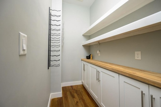 bar with baseboards and dark wood-type flooring