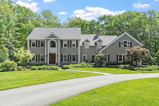 43 Stoneymeade Way, Acton, MA 01720 - colonial home featuring a chimney and a front lawn