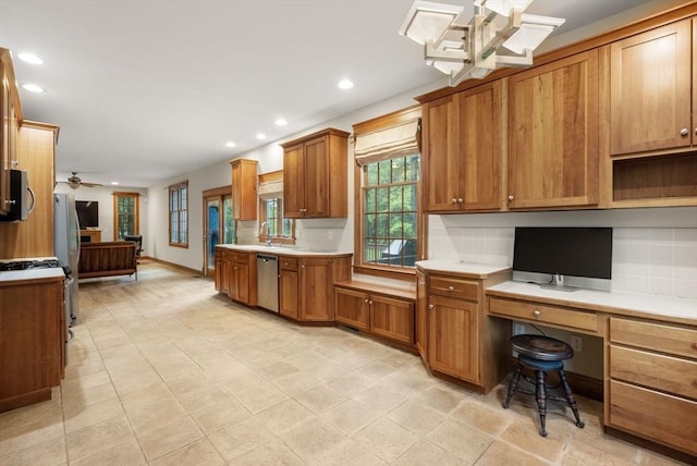 kitchen featuring brown cabinetry, decorative backsplash, appliances with stainless steel finishes, recessed lighting, and light countertops
