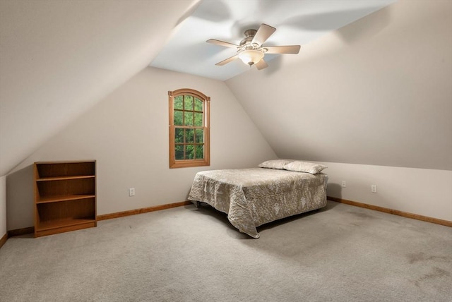 bedroom with carpet, lofted ceiling, baseboards, and a ceiling fan