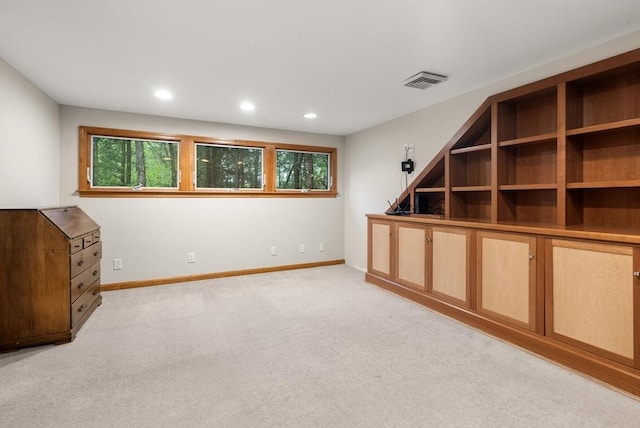 basement with baseboards, light carpet, and recessed lighting