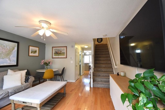 251 Sunderland Rd Unit 251, Worcester, MA 01604 - living area featuring stairs, a ceiling fan, light wood finished floors, and a textured ceiling