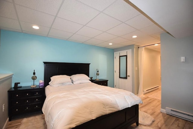 251 Sunderland Rd Unit 251, Worcester, MA 01604 - bedroom featuring a baseboard radiator, wood finished floors, a drop ceiling, and recessed lighting