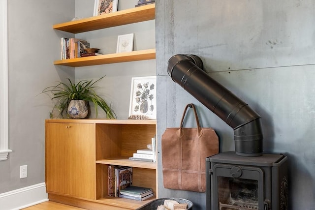 68 Cliftondale St, Boston, MA 02131 - detailed view of wood finished floors, a wood stove, and baseboards