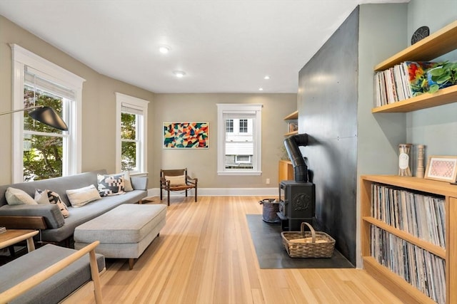 68 Cliftondale St, Boston, MA 02131 - living room with a wood stove, wood finished floors, recessed lighting, and baseboards