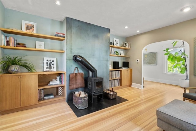 68 Cliftondale St, Boston, MA 02131 - living room with a wood stove, wood finished floors, recessed lighting, and baseboards