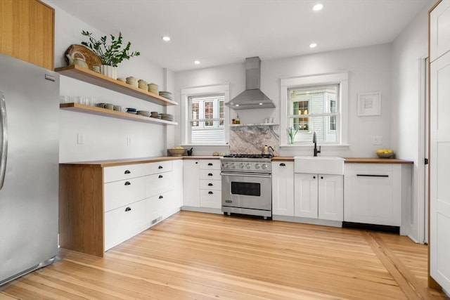 68 Cliftondale St, Boston, MA 02131 - kitchen with appliances with stainless steel finishes, wall chimney exhaust hood, a sink, open shelves, and recessed lighting