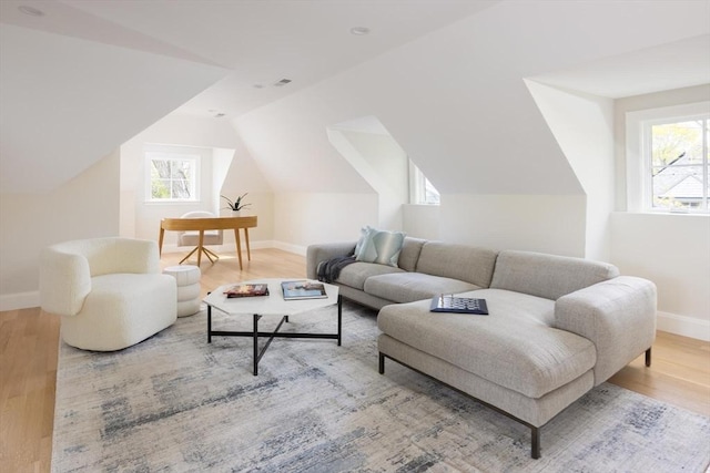 15 Woodcliff Rd, Newton, MA 02461 - living room with wood finished floors, baseboards, plenty of natural light, and vaulted ceiling