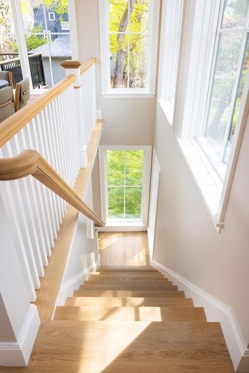 15 Woodcliff Rd, Newton, MA 02461 - staircase with wood finished floors, baseboards, and a high ceiling