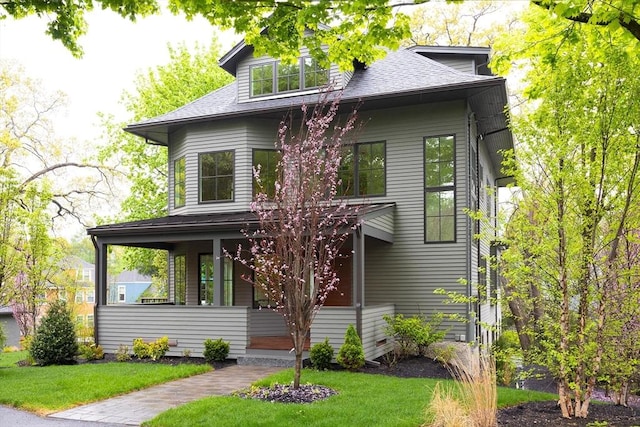 15 Woodcliff Rd, Newton, MA 02461 - view of front facade with a front yard, a shingled roof, and covered porch