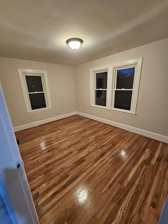 empty room featuring dark wood-type flooring