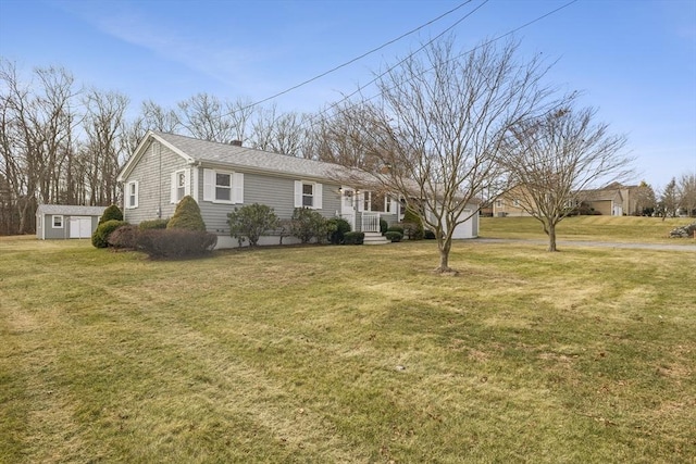 ranch-style house featuring a shed and a front lawn