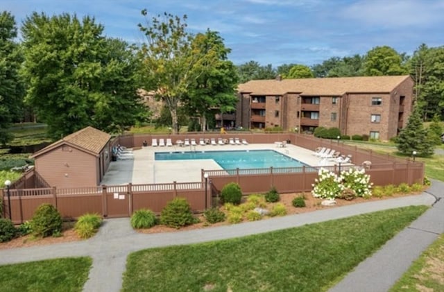 community pool with fence private yard, a gate, and a patio area