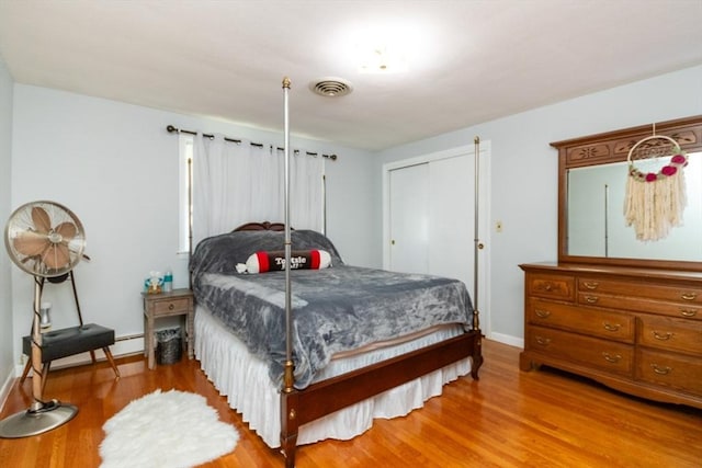 bedroom with wood finished floors and baseboards