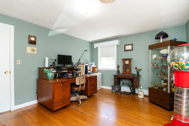 home office with light wood-style flooring, baseboards, and baseboard heating