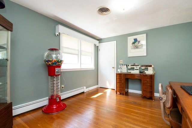 office featuring wood finished floors, a baseboard radiator, and baseboards