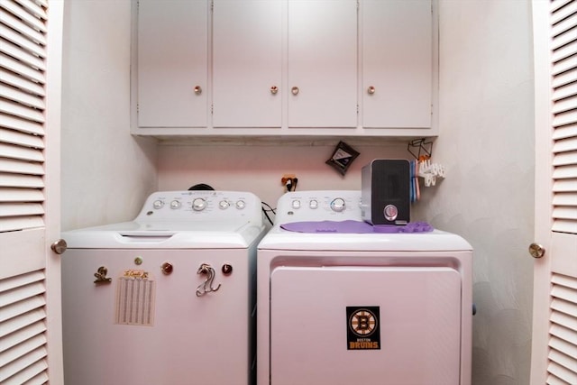 laundry room with washer and clothes dryer and cabinet space