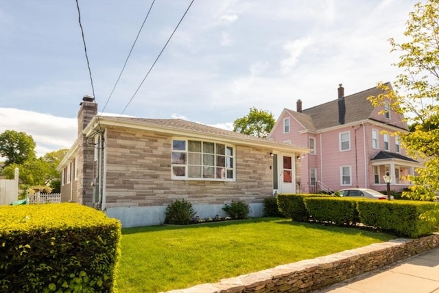 view of front of property with stone siding and a chimney