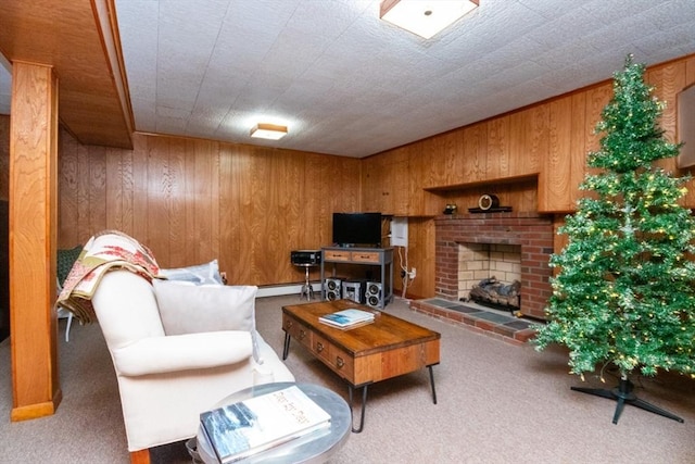 living area with carpet floors, wood walls, a baseboard heating unit, and a fireplace