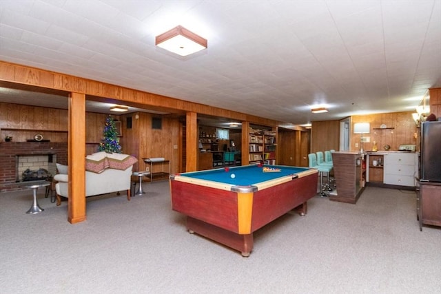 playroom with wooden walls, carpet flooring, pool table, and a fireplace