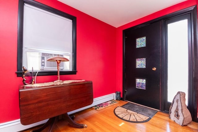 entryway with wood finished floors and cooling unit