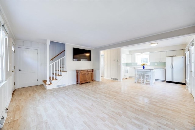 unfurnished living room with light wood-type flooring