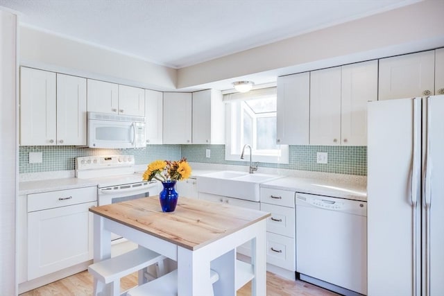 kitchen featuring light wood-type flooring, white appliances, and white cabinetry