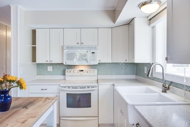 kitchen with white appliances, sink, tasteful backsplash, butcher block countertops, and white cabinetry