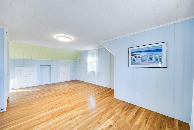 bonus room with light hardwood / wood-style floors and lofted ceiling