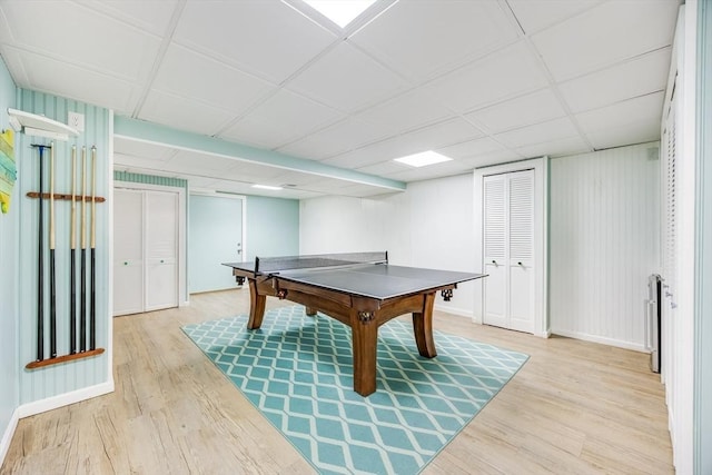 recreation room with hardwood / wood-style floors and a drop ceiling