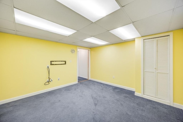 basement with a drop ceiling and carpet floors