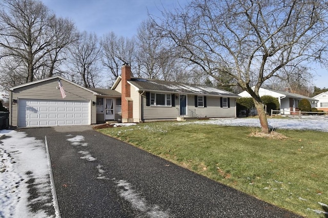 ranch-style home with a front yard and a garage