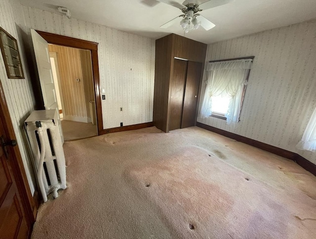 unfurnished bedroom with ceiling fan and light colored carpet