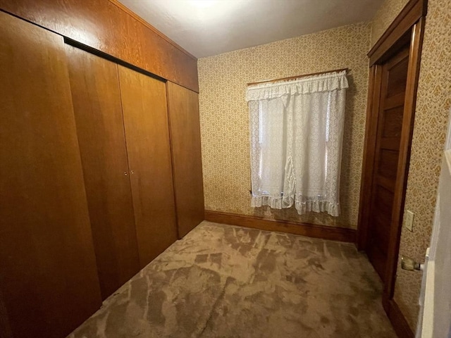 unfurnished bedroom featuring a closet and carpet flooring