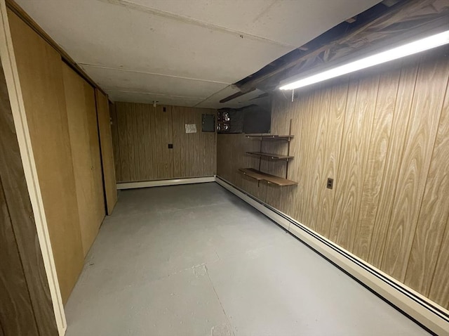 basement with baseboard heating and wood walls