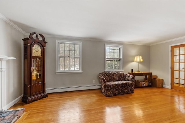 sitting room featuring light wood-type flooring, ornamental molding, and baseboard heating