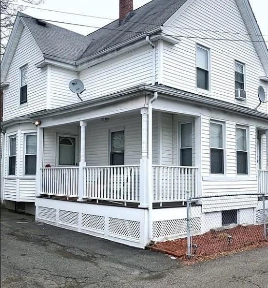 view of side of home with covered porch