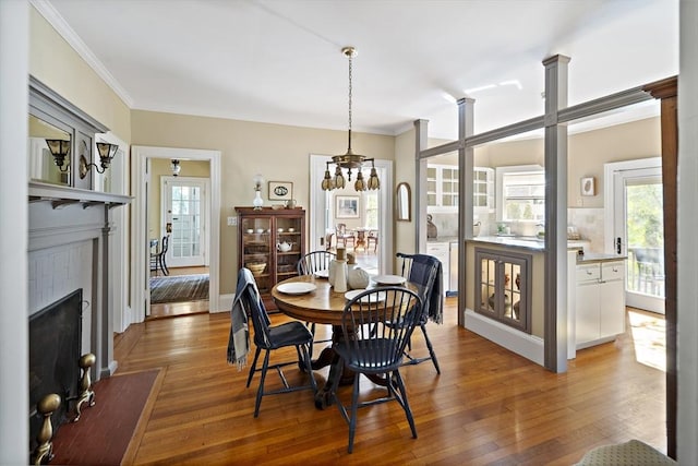 6 Francis Circuit Unit 6, Winchester, MA 01890 - dining room featuring crown molding, a fireplace with flush hearth, wood finished floors, and a chandelier